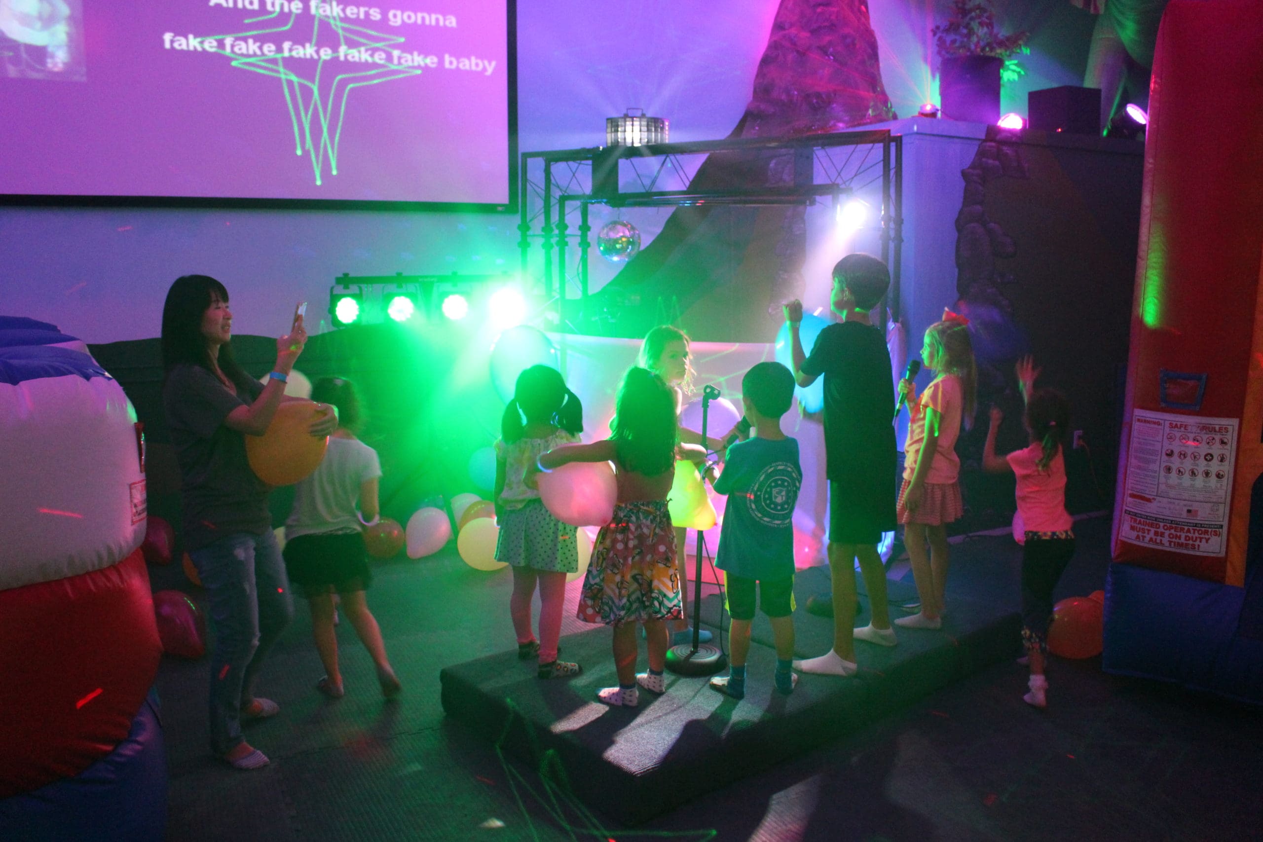 Kids singing karaoke during their jungle party here at Kicky & Tink's Playhouse